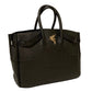 Black leather handbag side profile with gold hardware. This bag has top handles and adjustable sizes. the handbag is handmade in Boston Massachusetts. The logo. is Bellerophon on the back of pegasus rearing.